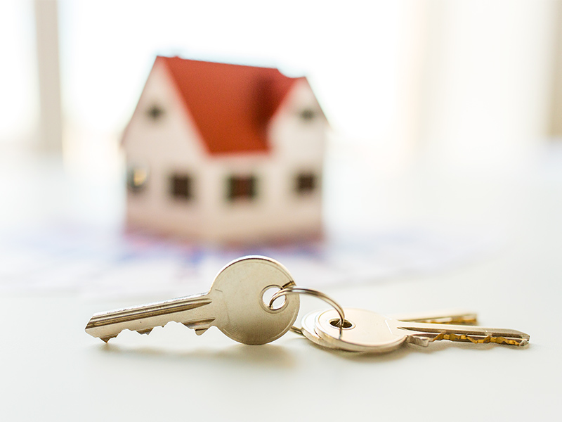 Close up of home model, money and house keys