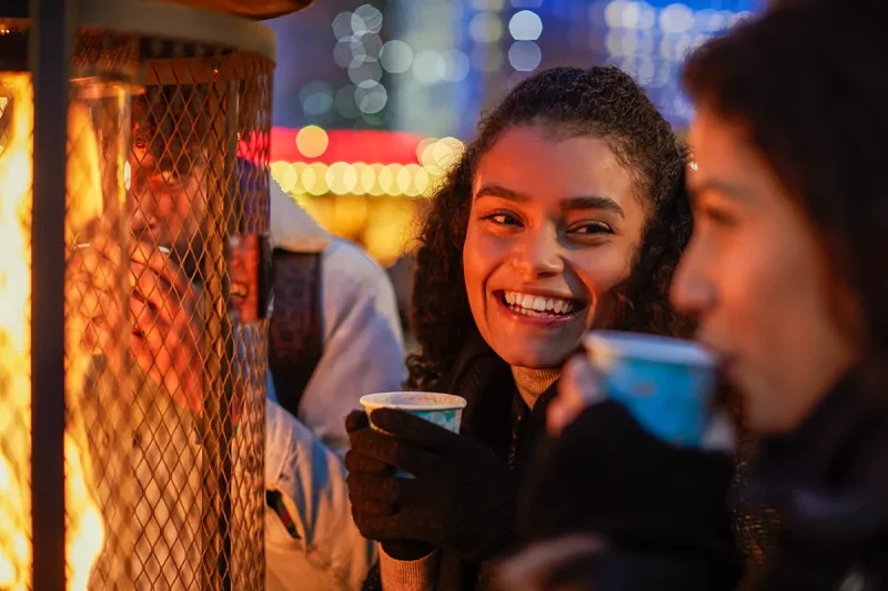 A group of friends enjoy mulled wine at a Christmas Market